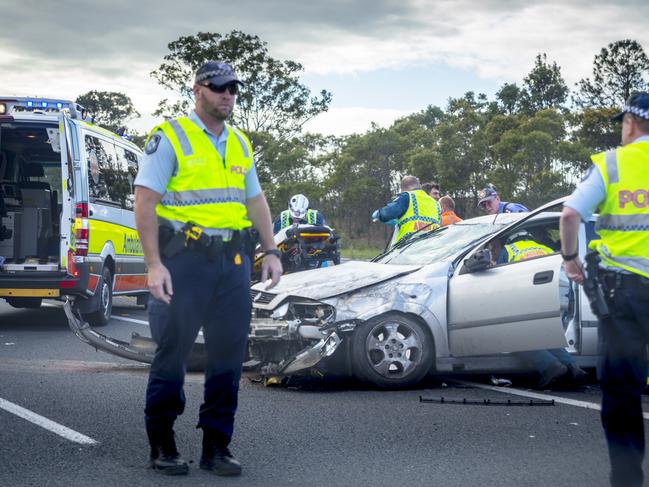 Narangba,Australia,July 25,2013: Car accident on the Bruce Highway in Queensland . An accdent when a car veered of the road and hit another car spinning it around,the image show attendance by both the  Queensland Ambulance service and the Queensland police force