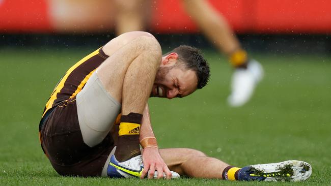 Jack Gunston grimmaces in pain after re-injuring his ankle. Picture: Michael Willson/AFL Photos via Getty Images