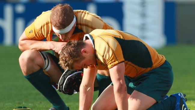 Wallabies Dan Vickerman (behind) and Matt Giteau come to terms with their loss to England at Marseilles in the 2007 Rugby World Cup. Picture: AP