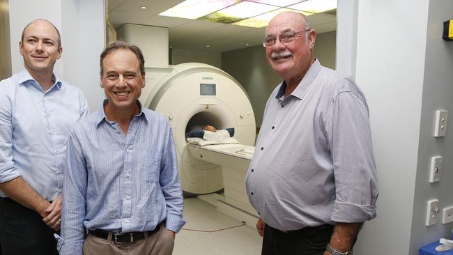 Radiologist Dr Daniel Webb with Federal Health Minister Greg Hunt and Federal Leichhardt MP Warren Entsc. Picture: Anna Rogers