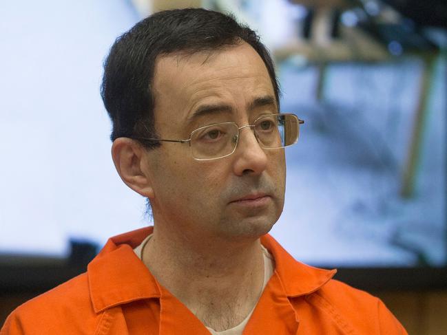 (FILES) In this file photo taken on February 5, 2018 former Michigan State University and USA Gymnastics doctor Larry Nassar appears in court for his final sentencing phase in Eaton County Circuit Court in Charlotte, Michigan. - American lawmakers made 15 recommendations to the US Olympic Committee on December 20, 2018 to better safeguard athletes from sexual abuse in the wake of the Larry Nassar gymnastics scandal. Suggestions by the House of Representatives Energy and Commerce Committee in its 133-page report included more USOC punishment options for 48 national sport governing bodies and open talk about sexual abuse without non-disclosure deals. (Photo by RENA LAVERTY / AFP)