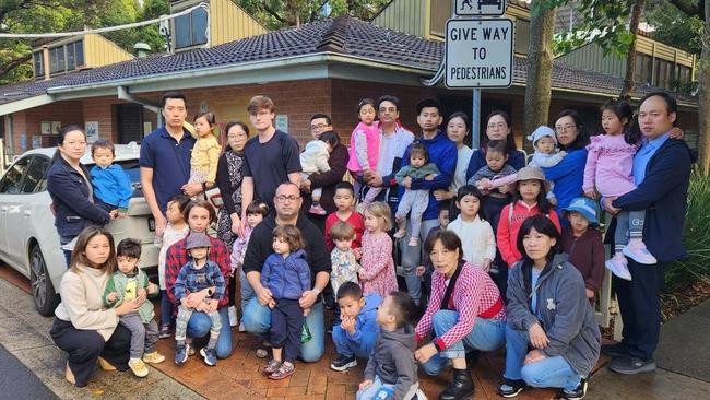 A photo of parents who have rallied against outsourcing the centre.