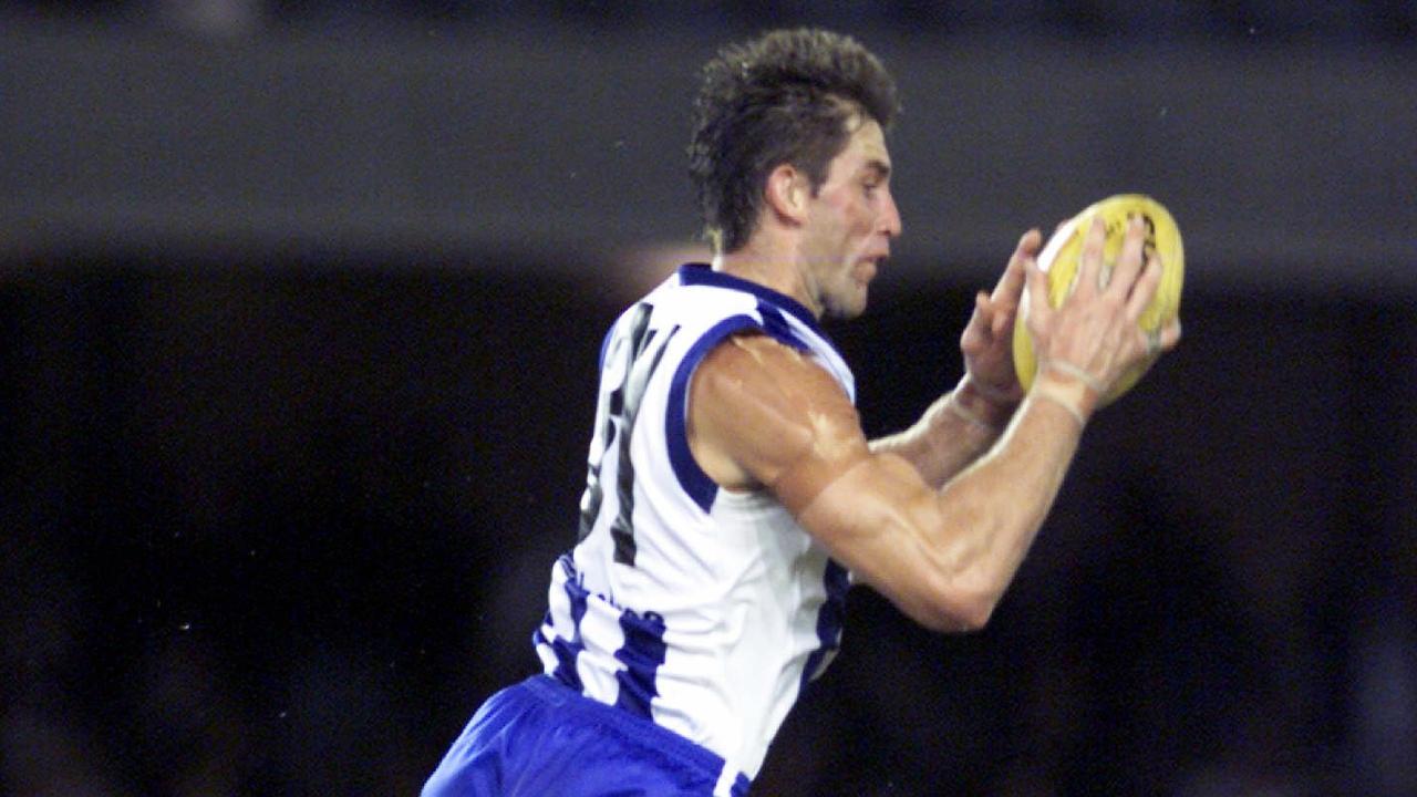 Corey McKernan taking a strong mark when he was playing with North Melbourne.