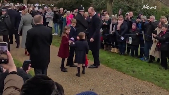 Prince Louis hands Princess Charlotte flowers