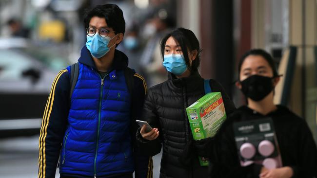 People wear masks in Melbourne CBD whie out buying groceries following the premier’s advice. Picture: Aaron Francis/The Australian