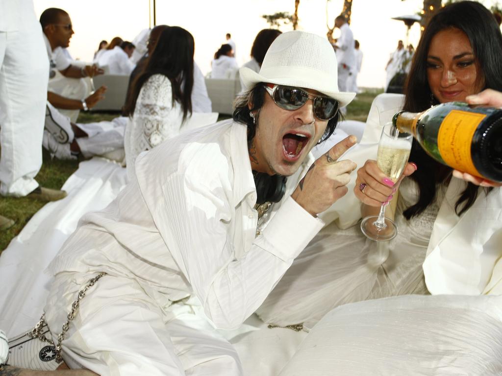 Mötley Crüe drummer Tommy Lee enjoys the champagne on offer. Picture: Mat Szwajkos/CP/Getty Images