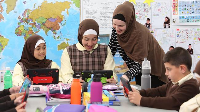 Al Hikma College students Khansa Cut Nofal, 10 and Ayah Said, 10, with teacher Jade McGinty. Picture: Robert Pozo