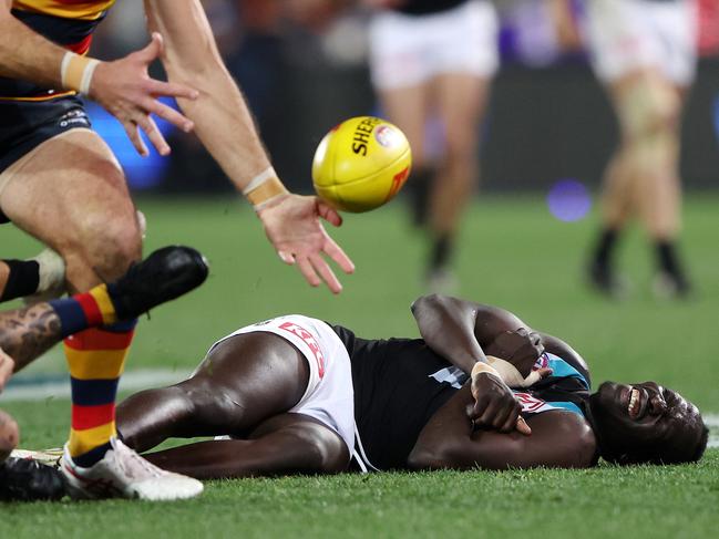 Aliir Aliir of the Power down after a collision with Lachie Jones in 2023. Picture: Sarah Reed/AFL Photos via Getty Images.