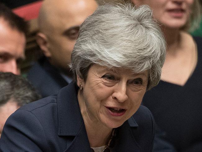 A handout photograph taken and released by the UK Parliament on March 27, 2019 shows Britain's Prime Minister Theresa May speaking during the weekly Prime Minister's Questions (PMQs) question and answer session in the House of Commons in London. - Prime Minister Theresa May on Wednesday pledged to step down if MPs back her EU divorce deal, in a bid to break the Brexit deadlock in Britain's fractured parliament. Her dramatic gambit came just two hours before MPs started a flurry of votes seeking a last-minute alternative Brexit plan to replace her deal. (Photo by JESSICA TAYLOR / UK PARLIAMENT / AFP) / EDITORS NOTE THE IMAGE HAS BEEN DIGITALLY ALTERED AT SOURCE TO OBSCURE VISIBLE DOCUMENTS  - RESTRICTED TO EDITORIAL USE - NO USE FOR ENTERTAINMENT, SATIRICAL, ADVERTISING PURPOSES - MANDATORY CREDIT " AFP PHOTO /JESSICA TAYLOR/ UK Parliament"