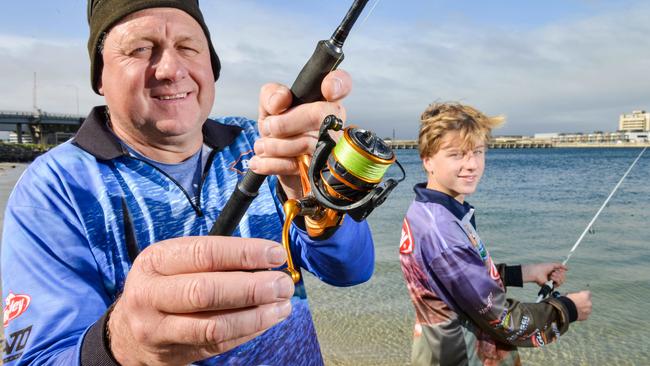 Recreational fisherman Tim Johnson and son Ryan fishing at the Port River on Sunday. Picture: Brenton Edwards