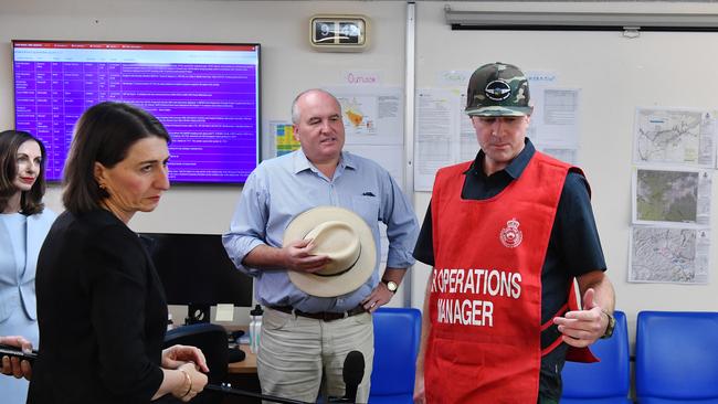 NSW Police and Emergency Services David Elliott, centre, pictured with Premier Gladys Berejiklian and USA Forest Service Air Operations manager Sean Cox, right. Picture: AAP