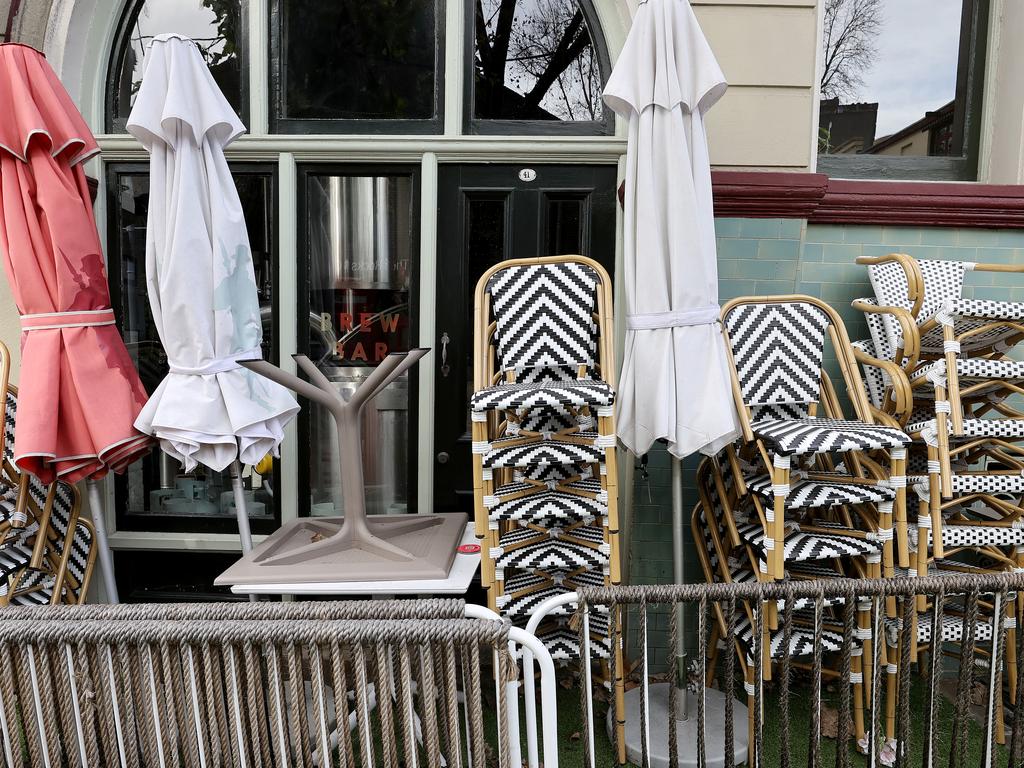 Tables and chairs stacked up outside a closed store in The Rocks. Picture: Toby Zerna