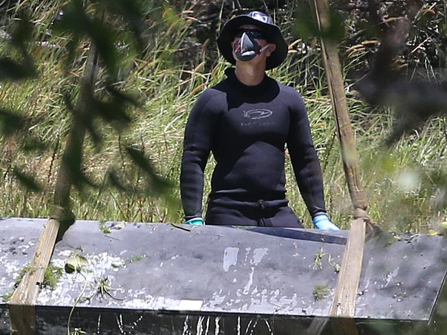 Toolbox murder -  Police retrieve a metal box from a dam near Srubby Creek in Kingston, double murder Logan. Pic Jono Searle.