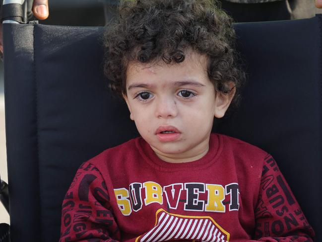 A volunteer transports a wounded Palestinian child off the plane upon their arrival in Abu Dhabi. Picture: AFP