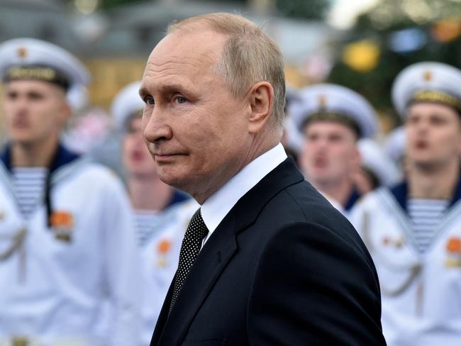 Vladimir Putin reviews naval troops as he attends the main naval parade marking the Russian navy Day, in St. Petersburg. Picture: AFP