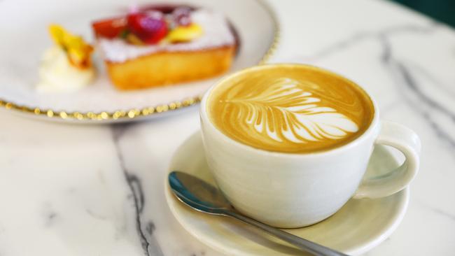 Coffee served with a Raspberry and Lemon Friand at Annie Lane Cafe. Picture: Lachie Millard