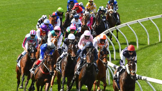 McNeil riding Twilight Payment leads the field around the first bend in the Cup.