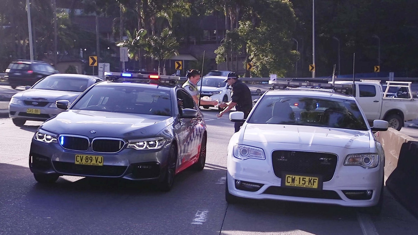 Officers from Coffs/Clarence Traffic and Highway Patrol following an alleged high speed pursuit which started at Glenugie and ended near the Big Banana at Coffs Harbour. Photo: Frank Redward