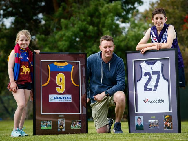 SCHOOL PRIDE: Naracoorte South Primary School students Matilda, 7, teacher Paul McCarthy and Harry Clark, 12, with the school’s Lachie Neale guernseys. Picture: Matt Turner