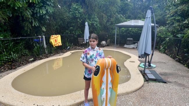 Nyah Waugh, 9, at the pool of her Forrestry Road home inundated by a fast rising Bluewater Creek. Picture: Evan Morgan