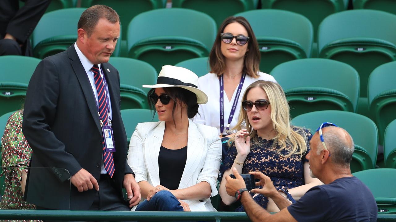 A man takes a selfie at Wimbledon as Meghan sits behind him. Picture: Mike Egerton/PA Images via Getty Images