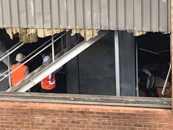 Investigators inspect fire damage within the main building at Rent A Space, Brookvale. Picture: NSW Fire &amp; Rescue.