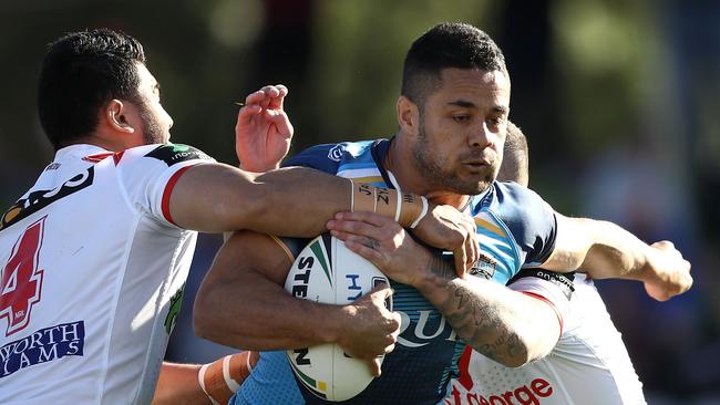 Jarryd Hayne is tackled by the Dragons defence.