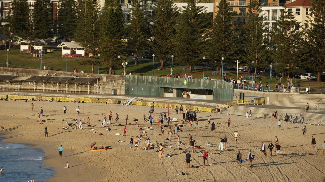 Large crowds of people on Coogee beach this morning before the beach closed at 9am. Photo: Tim Pascoe