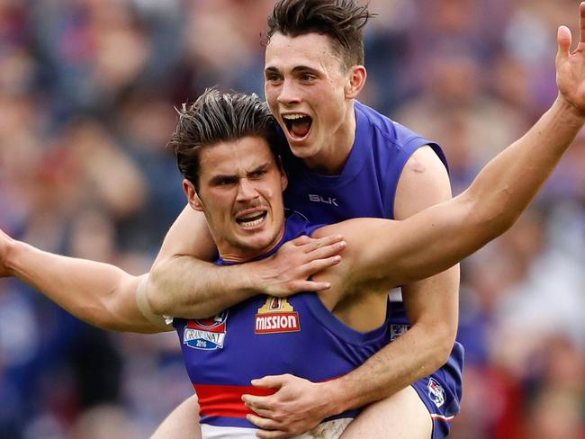 MELBOURNE, AUSTRALIA - OCTOBER 01: Tom Boyd of the Bulldogs celebrates a goal with Toby McLean of the Bulldogs during the 2016 Toyota AFL Grand Final match between the Sydney Swans and the Western Bulldogs at the Melbourne Cricket Ground on October 01, 2016 in Melbourne, Australia. (Photo by Adam Trafford/AFL Media/Getty Images)