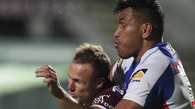 Manly's Daly Cherry-Evans is tackled by Newcastle's Daniel Saifiti in the NRL.