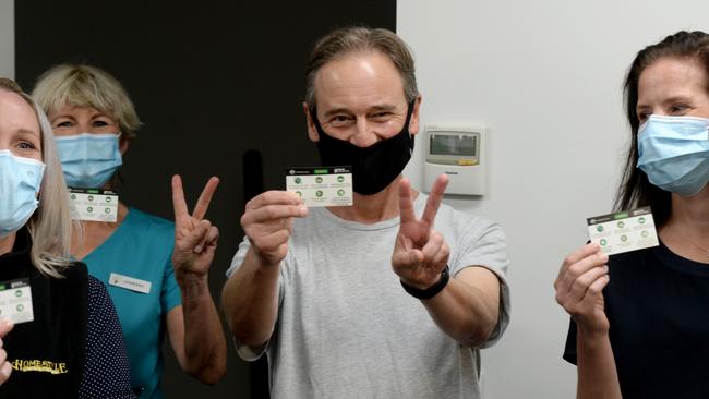 Federal Health Minister Greg Hunt displays his inoculation cards after receiving his Astrazenica vaccine. Picture: Andrew Henshaw