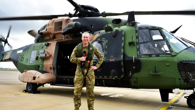 Mark Beretta on board an MRH-90 during a flypass over the Townsville 400 Supercars event. Picture: Alix Sweeney