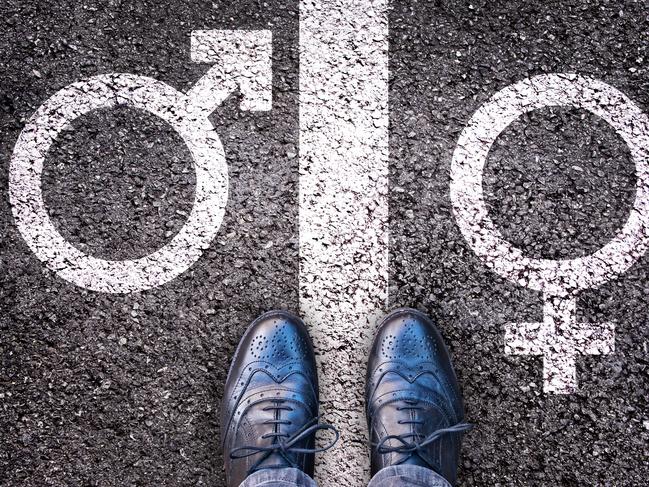 Legs with gender symbol on asphalt, gender concept. Istock