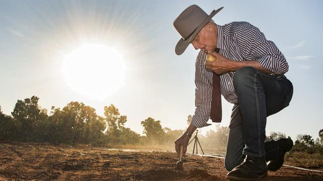 Kennedy MP Bob Katter plants a potato at Doomadgee using an ice cream scoop as his shovel. In the past Mr Katter has expressed concern for the bureaucracy that has prevented food from being allowed to grow in the Indigenous communities he represents. Picture: Brian Cassey