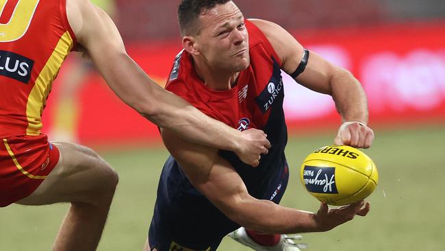 Melbourne's Steven May handballs under pressure. Picture: Phil Hillyard