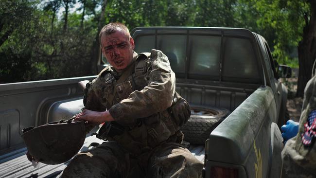 A wounded Ukrainian serviceman arrives at a stabilisation point near Bakhmut on Saturday. Picture: AFP