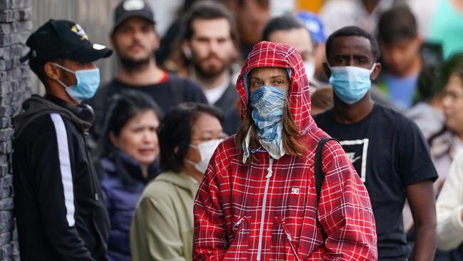 People are seen in long queue outside the Abbotsford Centrelink office in March 23.