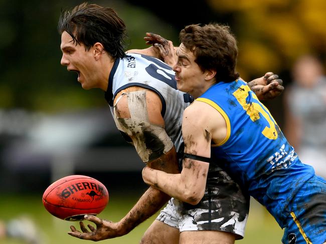 Lachlan Dunell of Old Geelong is tackled by Joshua Cumberlidge of De La Salle during the round eight 2023 Premier B Men's match between De La Salle and Old Geelong at Waverley Oval in Malvern East, Victoria on June 3, 2023. (Photo by Josh Chadwick)