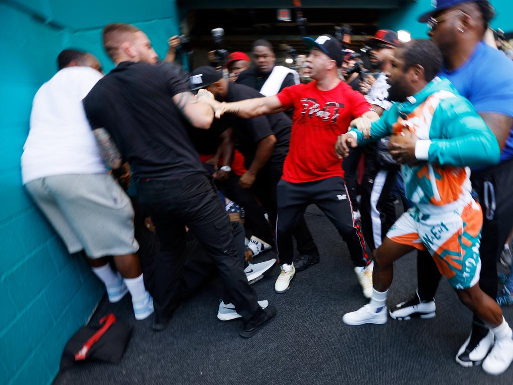 Floyd Mayweather and Jake Paul are separated by security. (Photo by Cliff Hawkins/Getty Images)