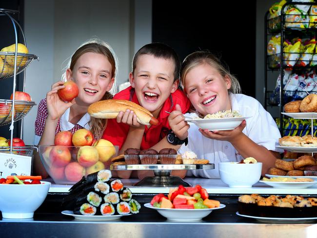 Malvern Valley Primary School students, Jess 11, Jonathan 9 and Tess 11 enjoy the food at their school canteen. Picture: Rebecca Michael