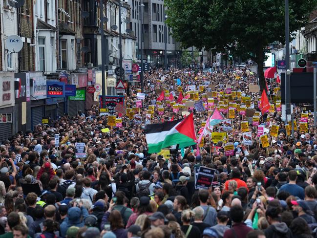 A Palestinian flag is waved as anti-racism counter-protesters gather in Walthamstow. Picture: Getty Images