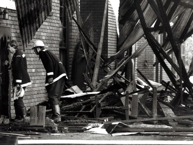 Firemen inspect the smouldering ruins of the Swagman restaurant in Ferntree Gully after it was destroyed by fire.