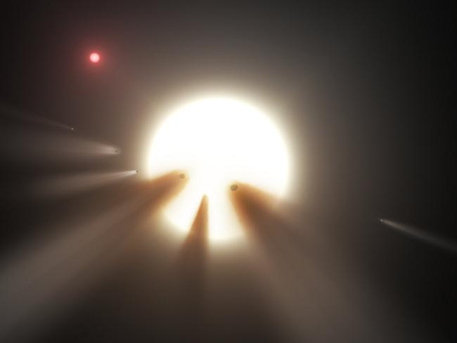 An artist's illustration showing a shattered comet passing in front of a star illustrates one theory that scientists have for the strange dimming star KIC 8462852. Picture: NASA/JPL-Caltech