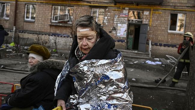 An injured woman receives medical treatment after shelling in a residential area in Kyiv. Ukraine’s president has pleaded with China to join the rest of the world in condemning Russia’s ‘barbarism’. Picture: AFP