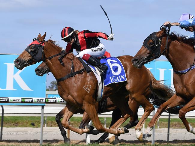 Tegan Harrison rides Dreams Aplenty (left) to victory in Race 4, the 1400m XXXX Gold Coast Cup at the Aquis Gold Coast Turf Club on the Gold Coast, Saturday, May 5, 2018. (AAP Image/Dave Hunt) 