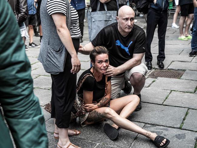 A woman is comforted outside Fields shopping mall, where a gunman killed three people and wounded several others in Copenhagen. Picture: AFP / Denmark OUT