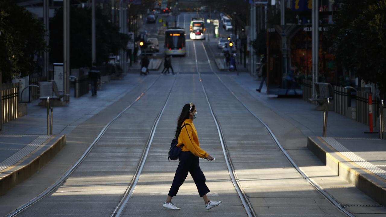 A woman crosses a quiet Bourke St on Saturday. Picture: NCA NewsWire/Daniel Pockett