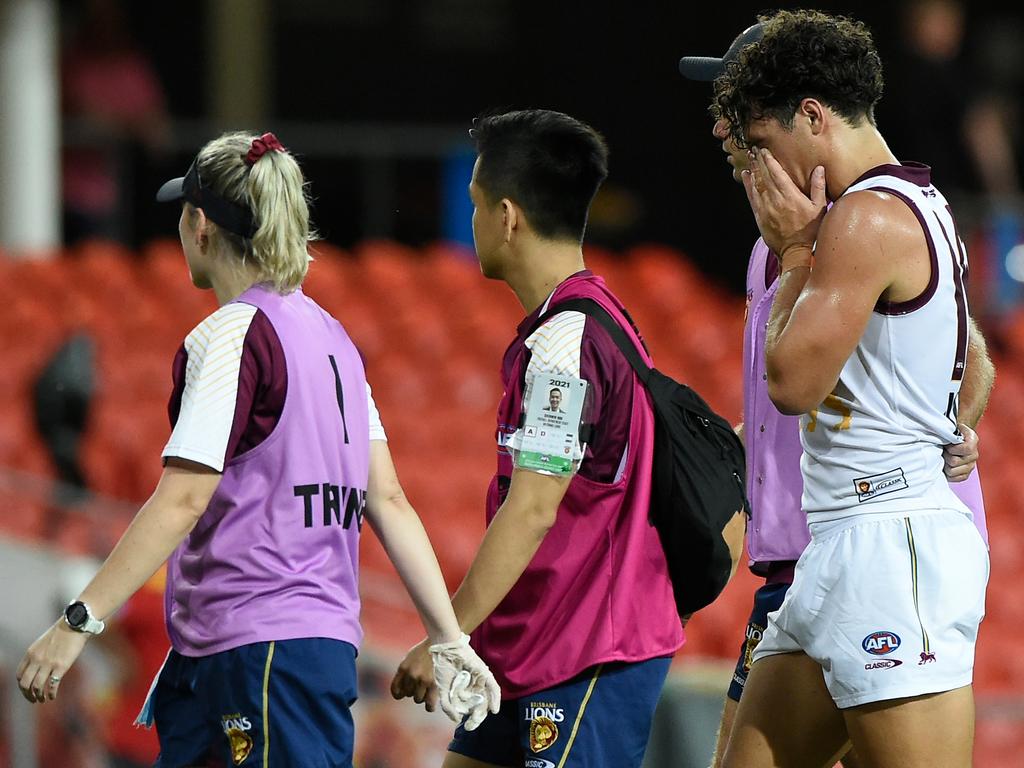 Cam Rayner of the Lions leaves the field injured.