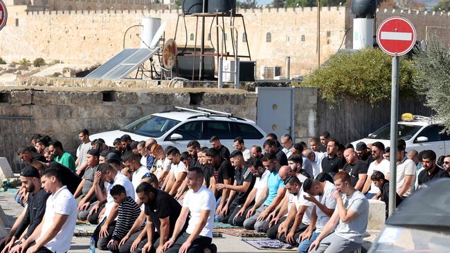 Muslim Palestinian men take part in Friday Noon prayers in the East Jerusalem neighbourhood of Ras al-Amud. Picture: AFP