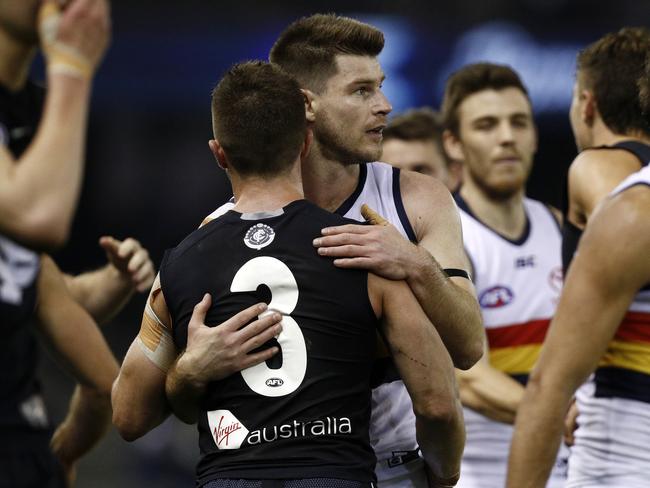 Bryce Gibbs of the Crows (centre) greets Marc Murphy of the Blues after the Round 23 AFL match between the Carlton Blues and the Adelaide Crows at Etihad Stadium in Melbourne, Saturday, August 25, 2018. (AAP Image/Daniel Pockett) NO ARCHIVING, EDITORIAL USE ONLY